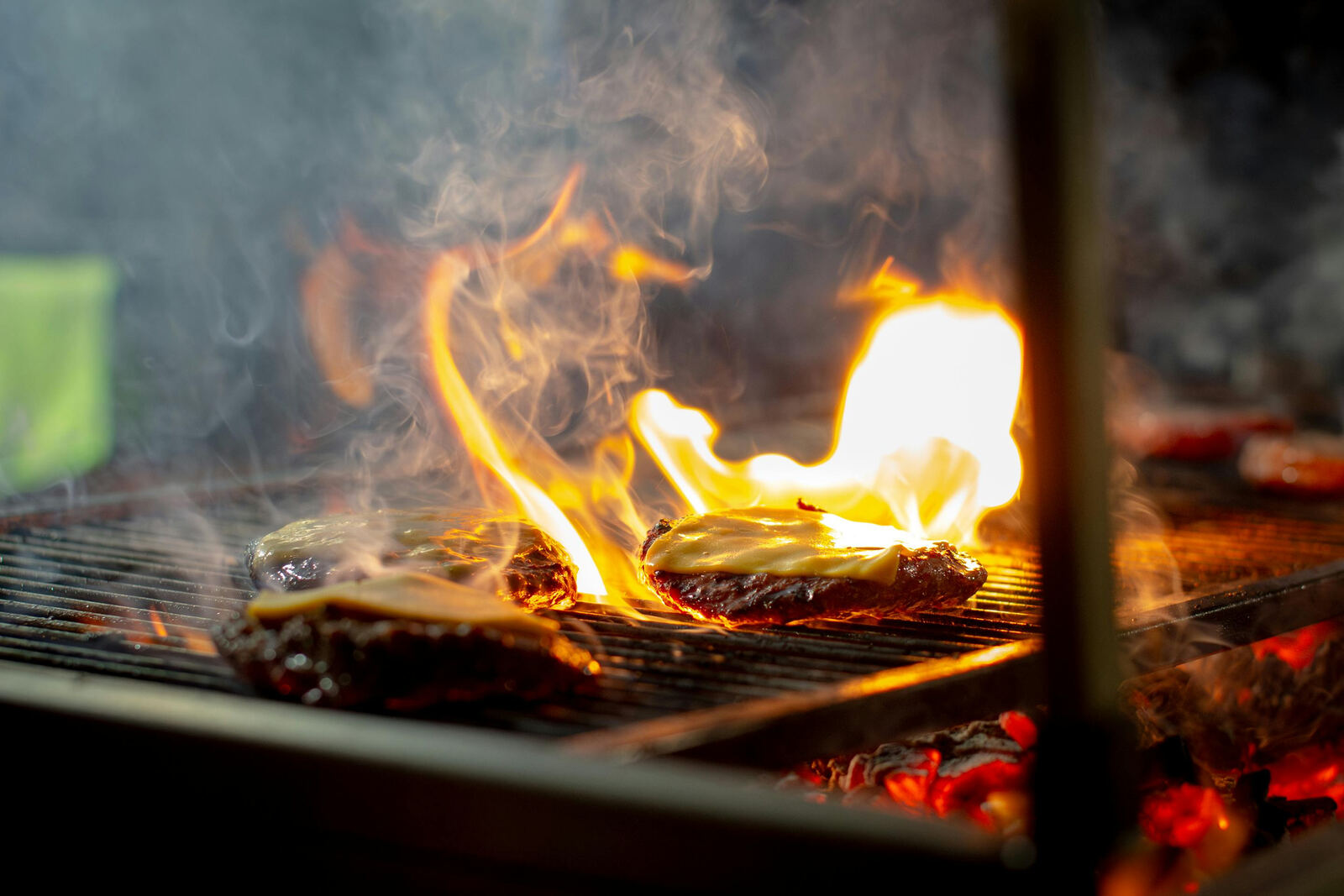 Burgers flame-grilling for a golf outing cookout